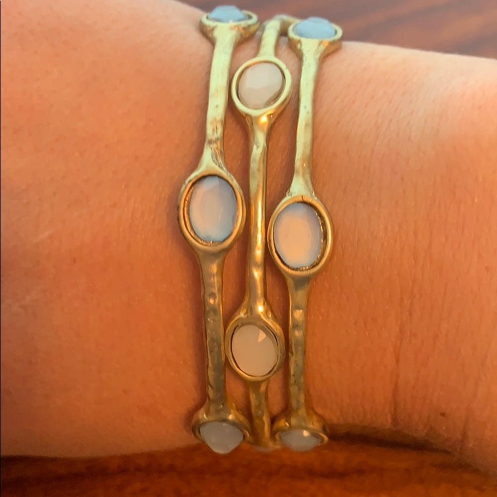 Gold tone, blue and white stone bangles.      (LA)